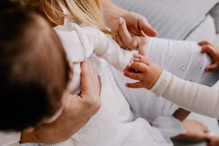 Close up detail of boy touching his baby girl hands. Newborn details. Newborn photography in Hampshire. Ewa Jones Photography