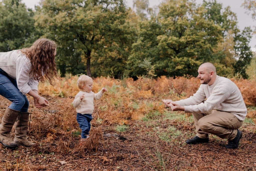 Little boy is trying to make is first steps. Family photo session in autumn. family moments. Hampshire photographer. Basingstoke family photo shoot. Ewa Jones Photography