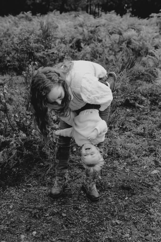 Mum is tickling his girl and she is laughing. Lifestyle family photo session. Basingstoke family photographer. Hampshire photographer. Ewa Jones Photography