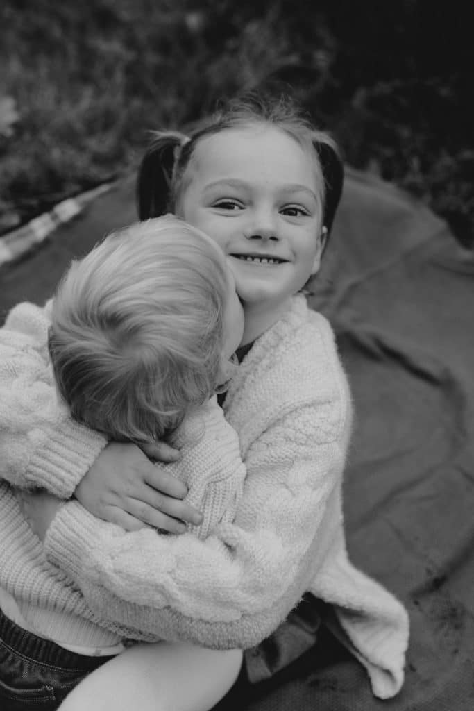 Brother and sister are cuddling to each other. Candid family moment. Hampshire family photo shoot. Basingstoke photographer. Ewa Jones Photography