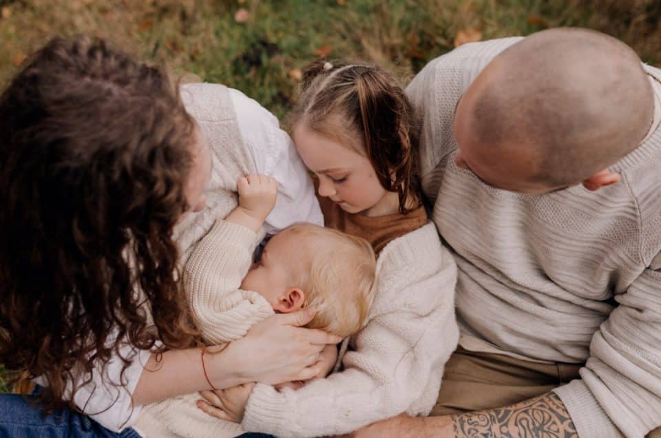 Family is cuddling together. lovely family photo shoot in Hampshire. Basingstoke family photographer. Ewa Jones Photography. family photo session in the autumn