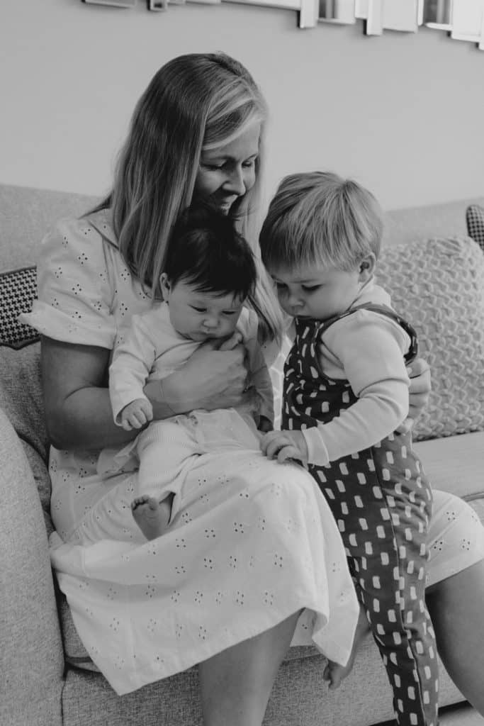 mum is cuddling her two children. candid natural moment. Hampshire newborn photo shoot. Hampshire photographer. Ewa Jones Photography.