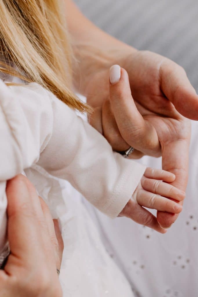 close image of baby hands with mummys hand. newborn photo shoot. detail shoot. Hampshire newborn photographer. Ewa Jones Photography.