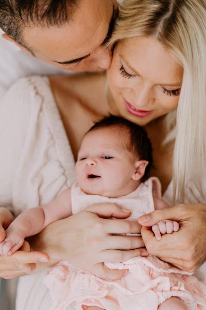 Newborn photo shoot in London-24 Mum and dad are cuddling their newborn baby girl close. natural lifestyle photo shoot. London newborn photography. Ewa Jones photography.