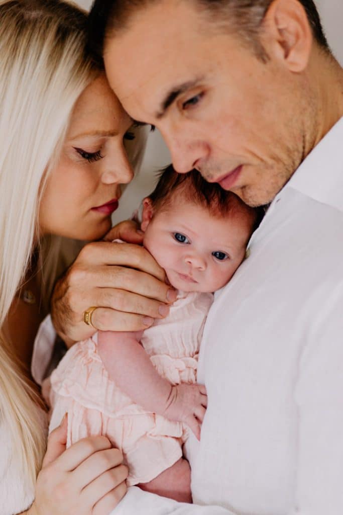 Newborn photo shoot in London-26 Mum and dad are cuddling their newborn baby girl close. natural lifestyle photo shoot. London newborn photography. Ewa Jones photography.