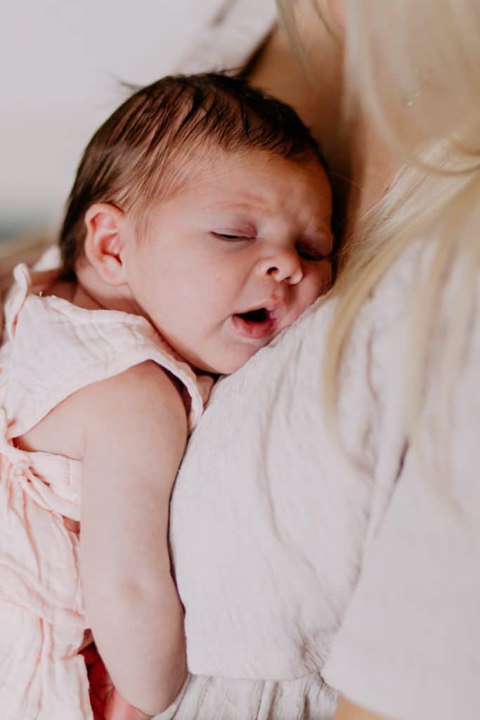 Newborn photo shoot in London-30 Baby girl is cuddling close to her mum and sleeping. Newborn baby photography in London. Hampshire photographer. Newborn baby photo session at home. Ewa Jones photography.