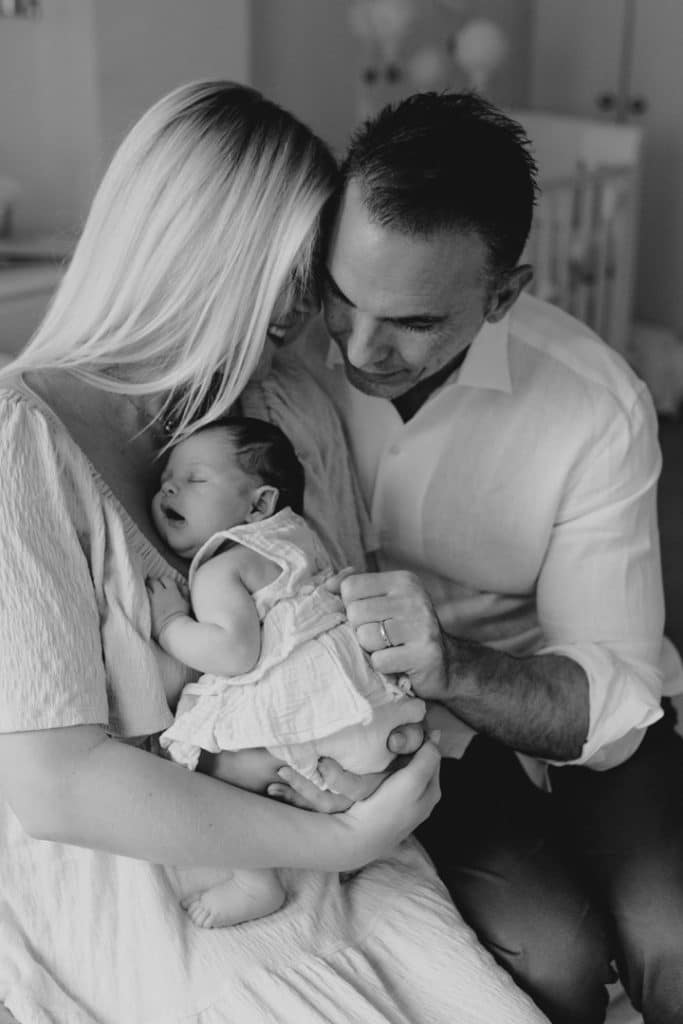 Newborn photo shoot in London-31 Mum and dad are cuddling their newborn baby girl. lovely candid photograph from a newborn baby session in London. Basingstoke photographer in London. Ewa Jones photography.
