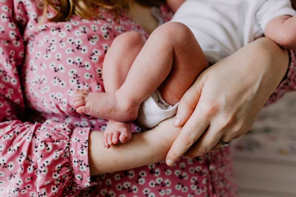 Close up of newborn baby feet. Mum is holding her newborn baby girl. Basingstoke newborn photo session. Hampshire photographer. Ewa Jones Photography