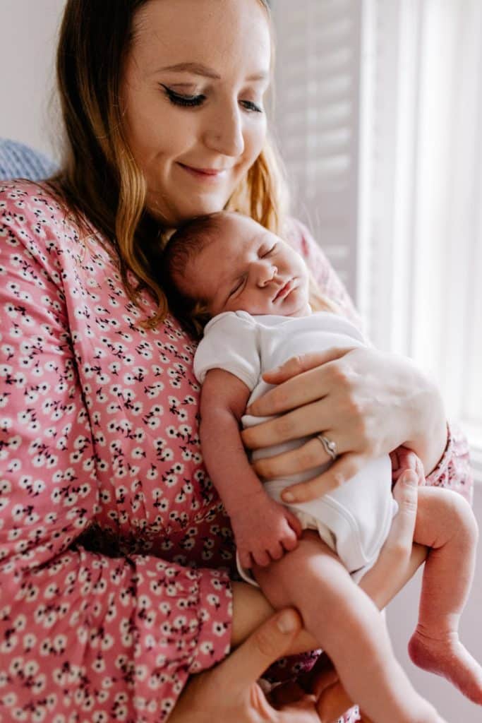 mum is holding her newborn baby. newborn baby is sleeping in mummy's arms. Basingstoke newborn photo shoot. Hampshire photographer. Ewa Jones Photography
