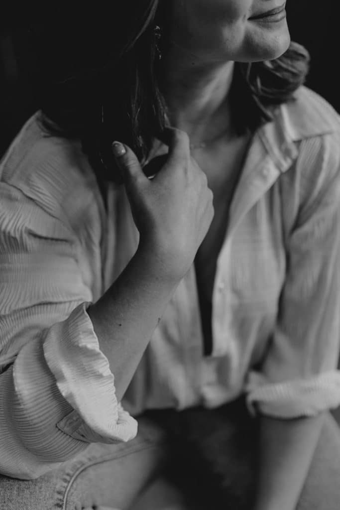 Empowering female sessions-1 Close up detail of female hand. she is touching her hair. black and white photograph. Hampshire photographer. Ewa Jones Photography