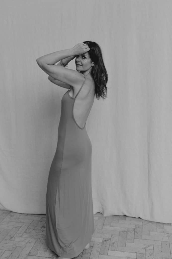 Empowering female sessions-38 Woman is looking through her hands. she is wearing lovely dress. Studio photo session. Self-love photo shoot in Hampshire. Ewa Jones Photography