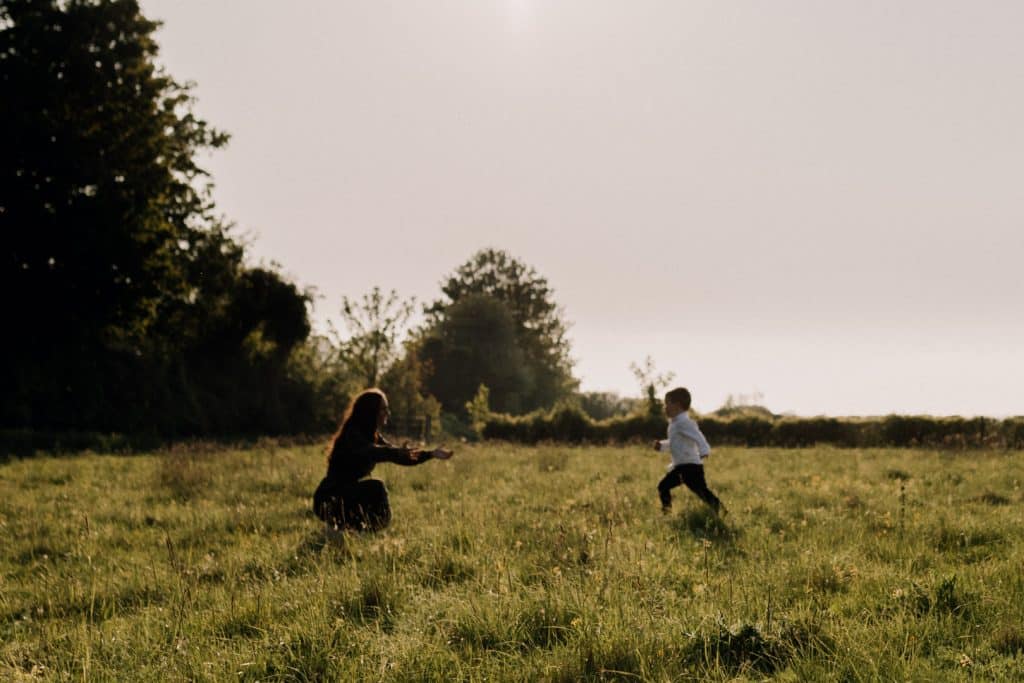 Claudia and Lorenzo-10 little boy is running to his mum. Family photo session in the fields in the spring. Hampshire family photographer. Basingstoke photographer. Ewa Jones Photography