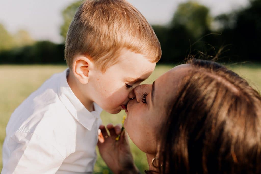 Claudia and Lorenzo-16 mum is kissing her little boy. Natural family photo session. Lovely spring evening for a photo shoot. Hampshire family photo session. Ewa Jones Photography