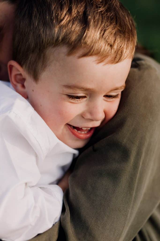 Claudia and Lorenzo-5 Little boy is cuddling close to his mum. he is happy. Family photo session in Hampshire. Hampshire family photographer. Ewa Jones Photography