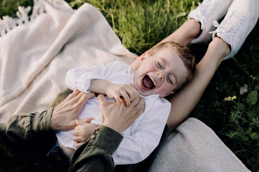 Claudia and Lorenzo-7 Mum is tickling her boy and he is laughing. Family photo shoot in Hampshire. Ewa Jones Photography