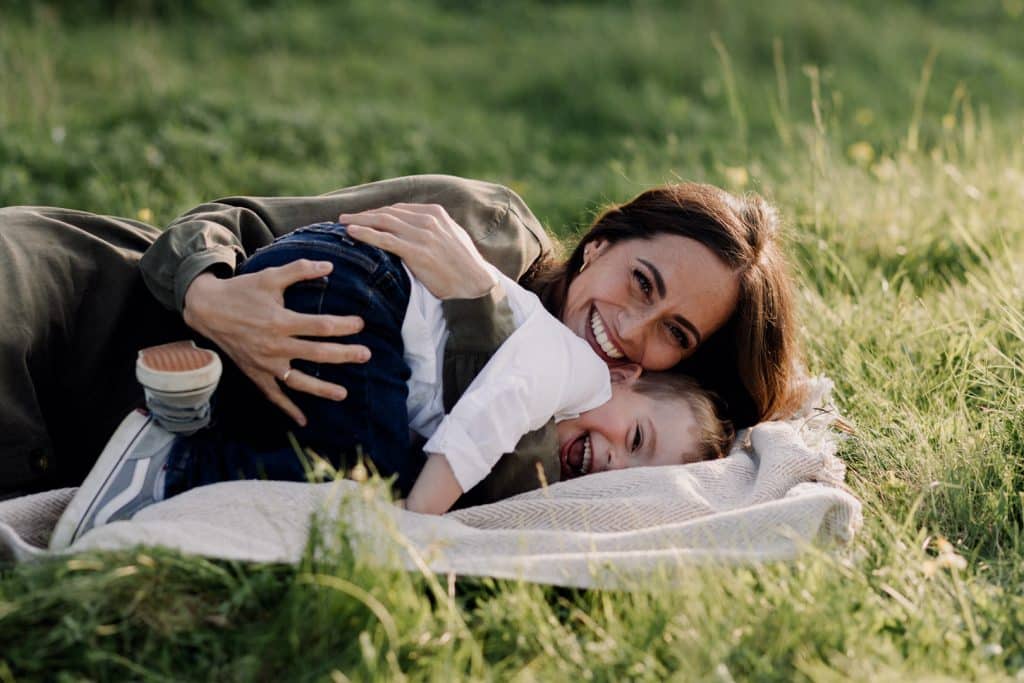 Claudia and Lorenzo-8 A Heartwarming Spring Photo Session with Mum and Son. mum is cuddling her boy and smiling. Fun in the fields. Mum and son photo session in Hampshire. Hampshire photographer. Ewa Jones Photography