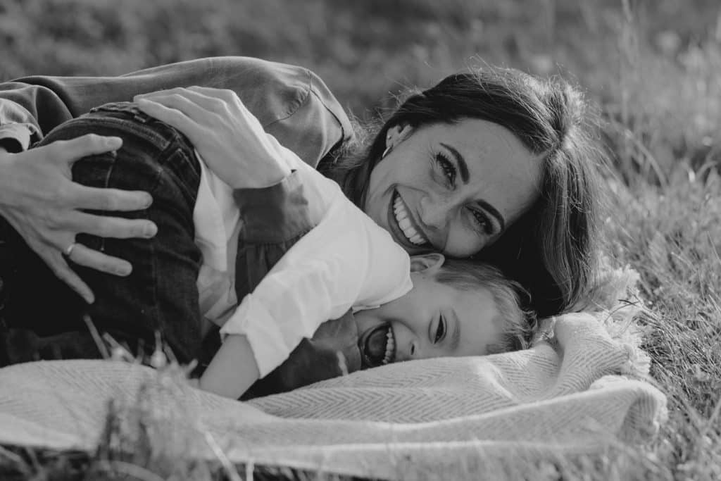 Claudia and Lorenzo-9 A Heartwarming Spring Photo Session with Mum and Son. mum is cuddling her boy and smiling. Fun in the fields. Mum and son photo session in Hampshire. Hampshire photographer. Ewa Jones Photography