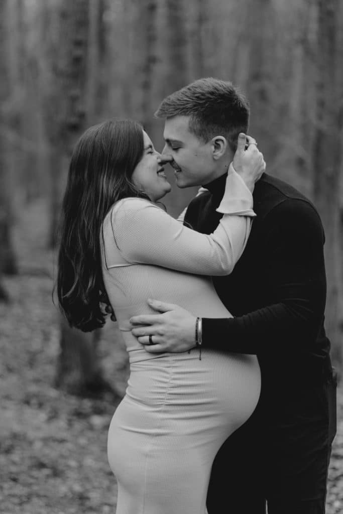 intimate maternity photo session. mum and dad are cuddling close and smiling to each other. what to wear for maternity photo session. Ewa Jones Photography.