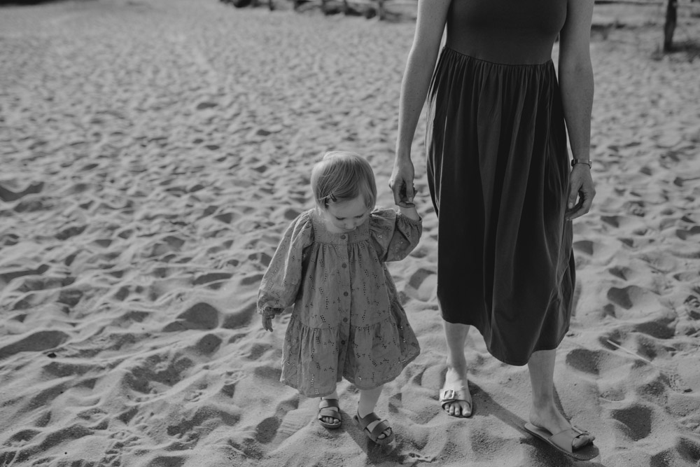 mum is holding daughters hand. Family outdoor photo session. Ewa Jones Photography