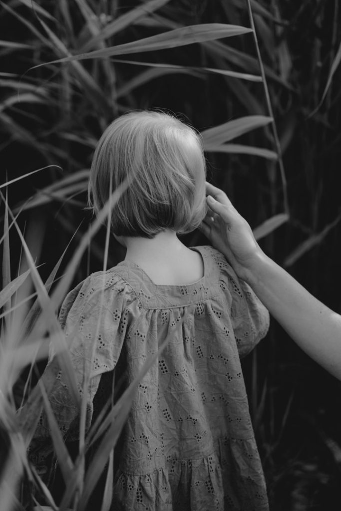 mum is touching daughter head. Lovely intimate image. Black and white photography. Hampshire photographer. Family photo session. Ewa Jones Photography