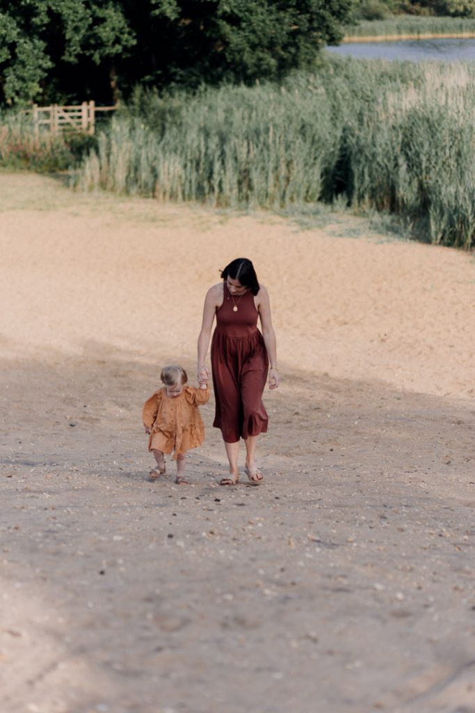 mum is holding hands with her daughter. photo session by the pond. Hampshire photo shoot. Hampshire photographer. Ewa Jones Photography