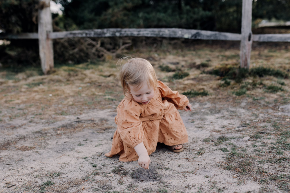 Little girl is playing in the sand. Family photo shoot. Family photographer in Basingstoke. Ewa Jones Photography