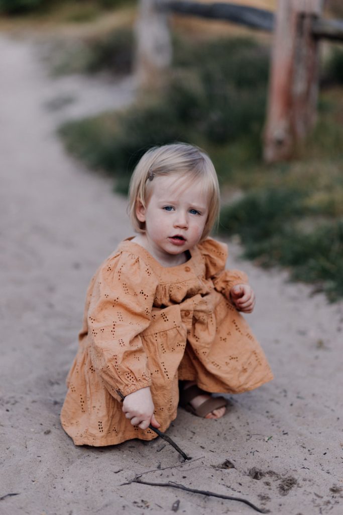Little girl is playing in the sand. Family photo shoot. Family photographer in Basingstoke. Ewa Jones Photography
