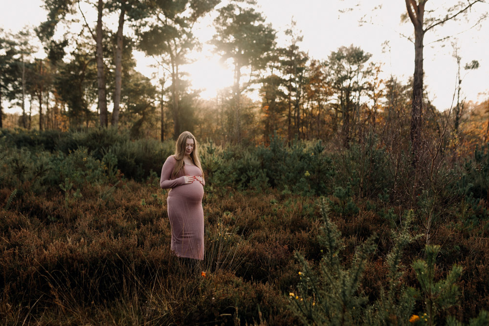 Maternity photo session in Basingstoke 06.12.24-8 Mum is looking down at her baby bump. natural common. Autumn maternity photo session. Ewa Jones Photography
