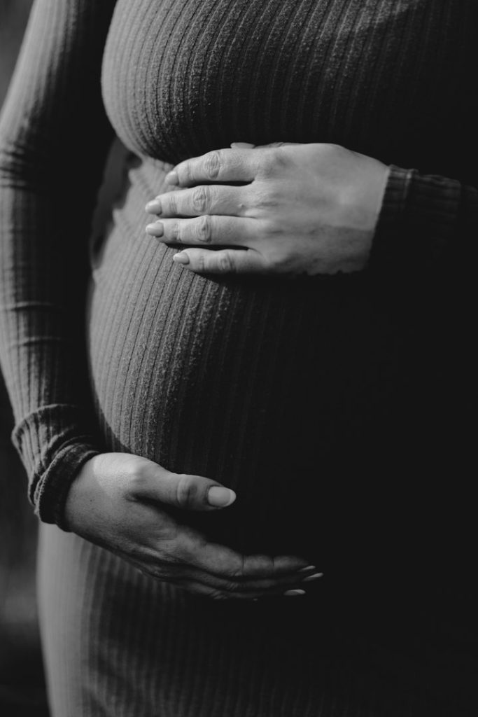 black and white photograph of close up of bump. Maternity session. Ewa Jones Photography