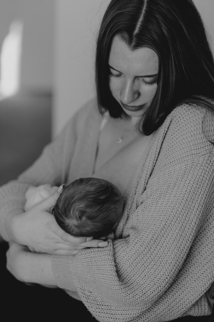 Newborn photo session in Basingstoke 19.01.24-14 Mum is breastfeeding baby girl. Hampshire newborn photo shoot. Ewa Jones Photography