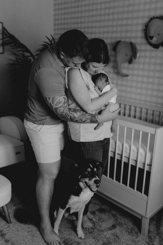 Parents are in baby nursery and cuddling close baby. Newborn photo shoot in Hampshire. Basingstoke photographer. Ewa Jones Photography