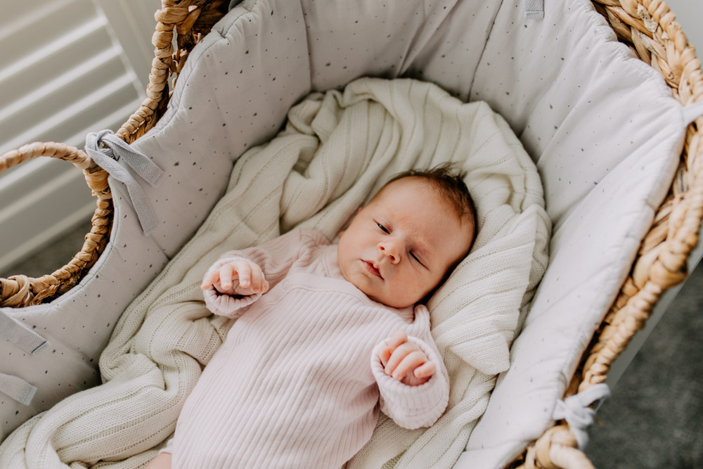 Baby girl is in her baby crib. in home newborn photo session. Hampshire newborn photo shoot. Ewa Jones Photography. Maternity and newborn sessions in Basingstoke