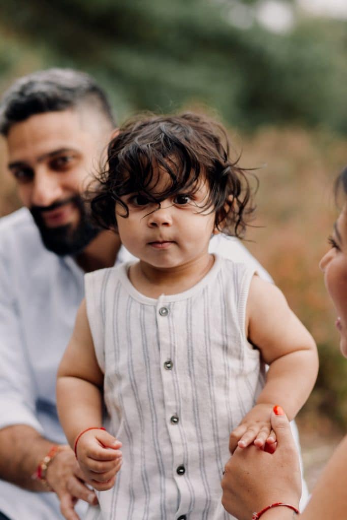 Little boy is standing and looking at the camera. family photo shoot. Family photographer. Ewa Jones Photography