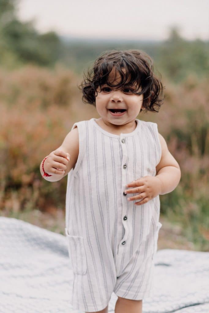 Boy is standing and smiling. Family photo shoot in Hampshire. Ewa Jones Photography