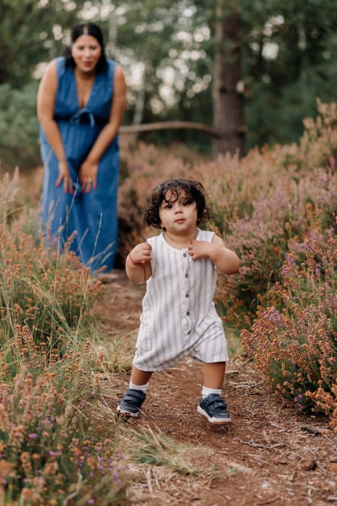 Little boy is running towards the camera. first steps. Celebrating first birthday party. Family session in the nature common. Ewa Jones Photography