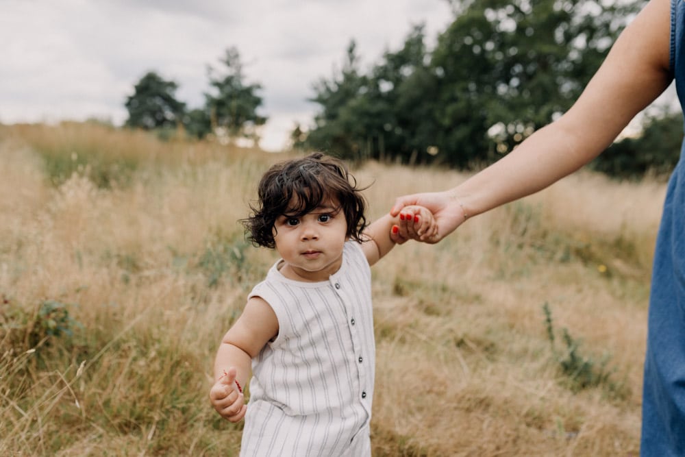 little boy is standing in the field. Lovely family photo session outdoors. how to prepare for a family session. Basingstoke family photographer. Ewa Jones Photography