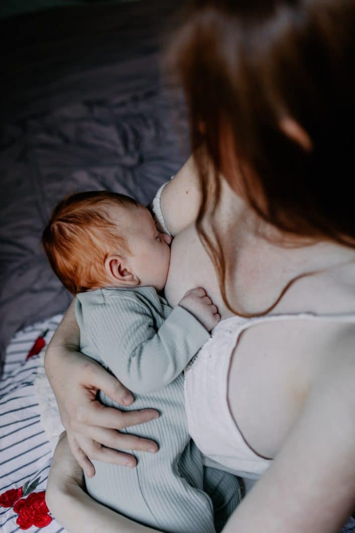 Mum is breastfeeding her little baby boy. newborn photo session. Newborn photographer. Ewa Jones Photographer