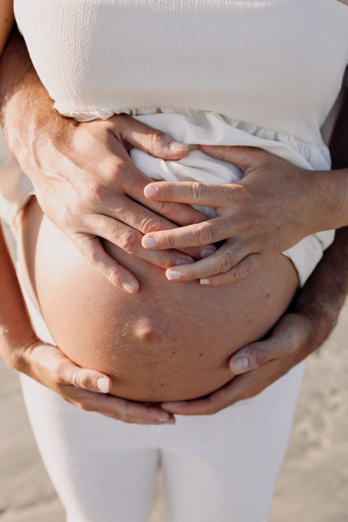 Close up of baby bump. Beach photo shoot at the beach. Hampshire photographer. Hampshire maternity photo shoot. Ewa Jones Photography
