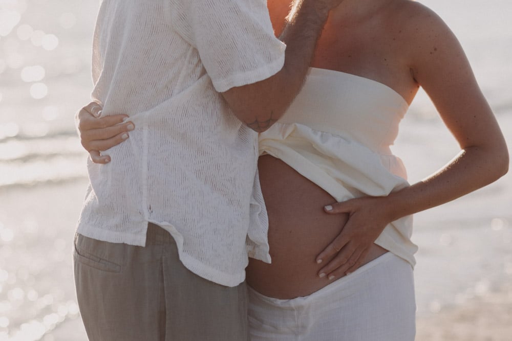 Close up baby bump. Maternity shoot at the beach. Intimate maternity photo shoot. Ewa Jones Photography