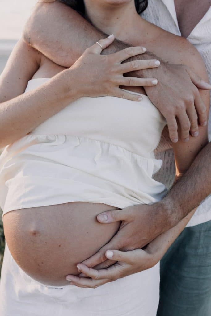 Close up image of the baby bump. Maternity photo session by the sea. Hampshire photographer. Ewa Jones Photography