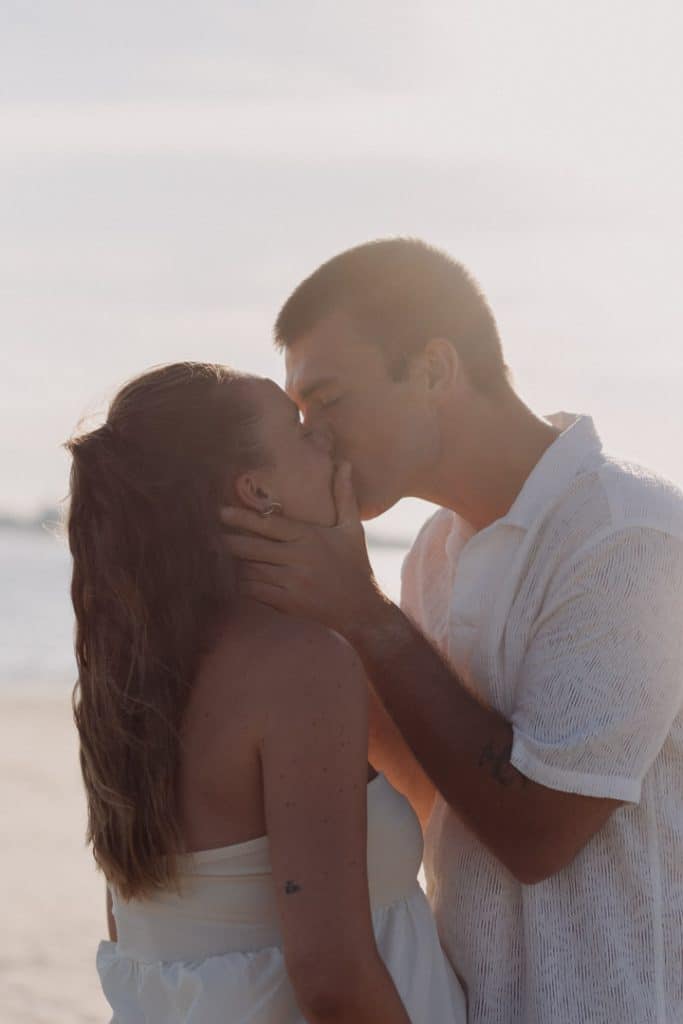 Parents to be are kissing. Lovely intimate maternity photo shoot at the beach. Maternity photographer. Hampshire maternity photographer. Basingstoke maternity photographer. Ewa Jones Photography