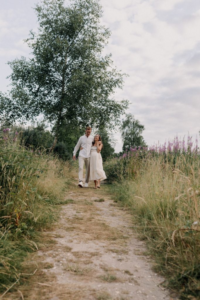 Expecting parents are walking and smiling. Maternity photo session. Hampshire photo shoot. Ewa Jones photography