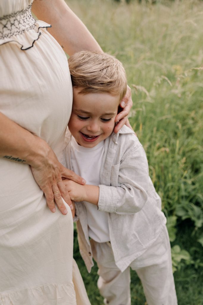 Little boy is cuddling to mum. baby bump photography. Family photo session. Hampshire photography. Ewa Jones Photography
