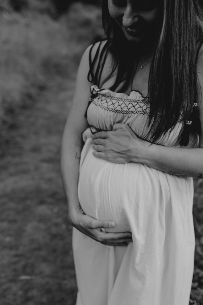 Close up of mum holding baby bump. maternity photo shoot. Maternity photo session. Maternity dress. Hampshire photographer. Basingstoke photographer.