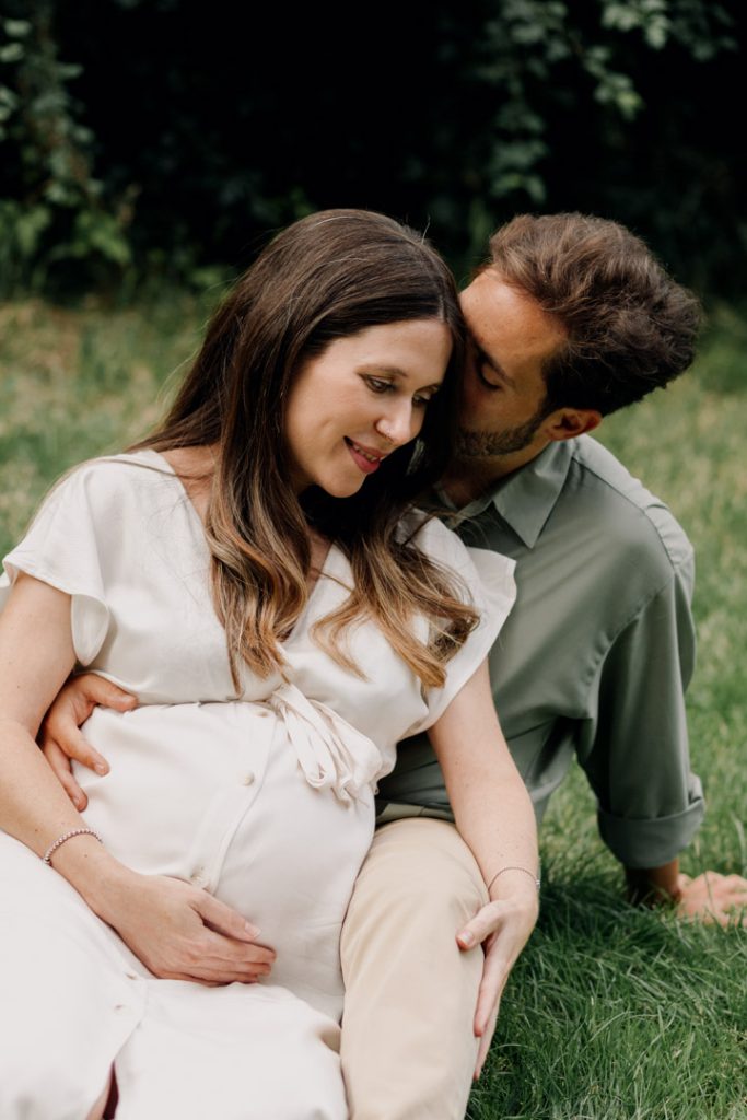 Parent to be are cuddling and being close with each other. Maternity outdoor session in London. Parents to be photo session. Ewa jones Photography