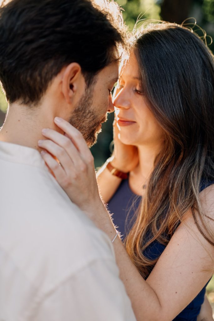 Expecting parents are cuddling. golden hour maternity Photo shoot. Hampshire Photographer.