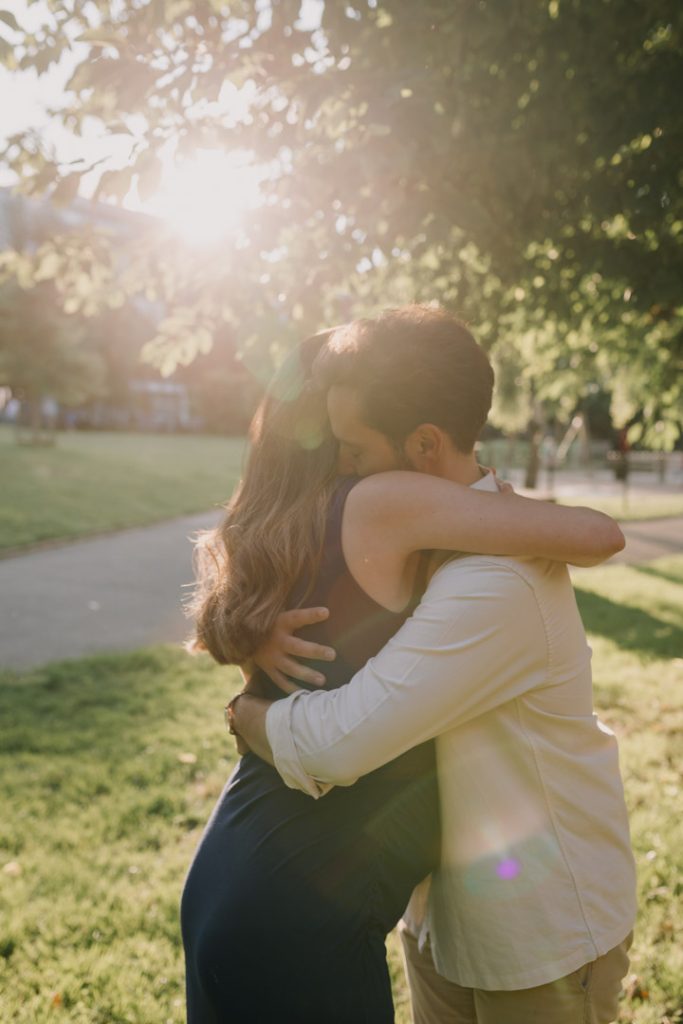 Expecting parents are cuddling. golden hour maternity Photo shoot. Hampshire Photographer.