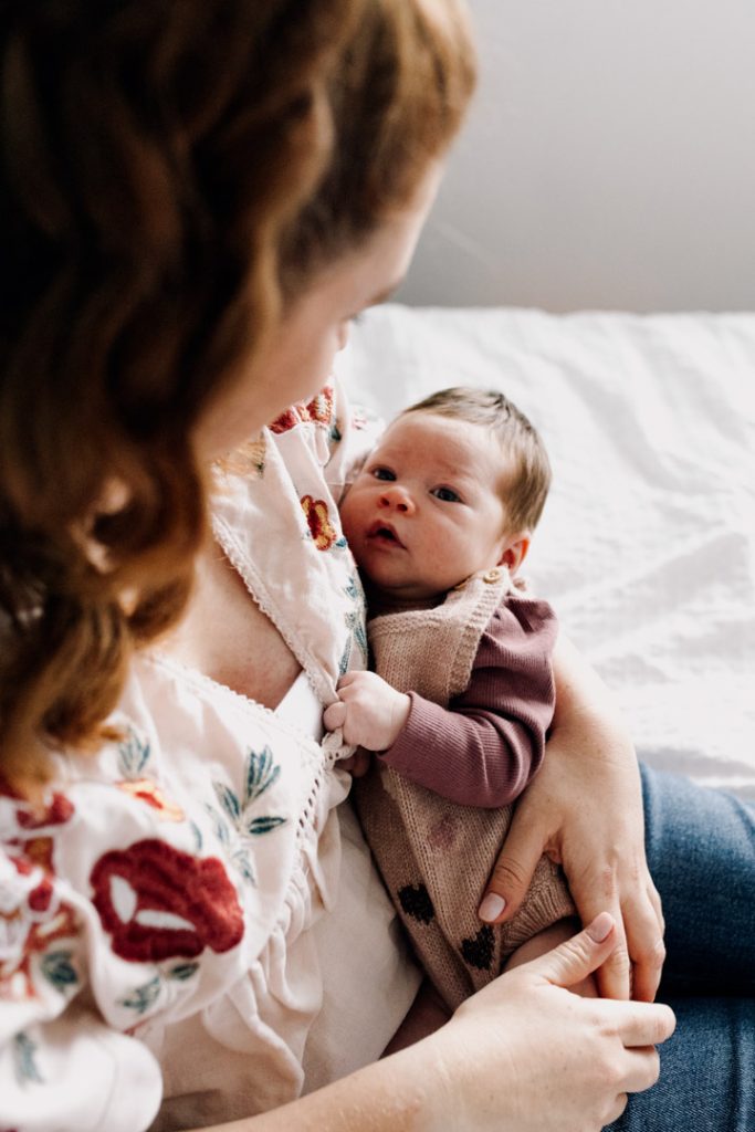 Mum is looking down at baby and cuddling. Hampshire newborn photo shoot. Ewa Jones Photography