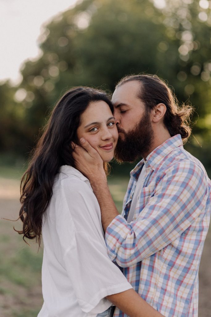 Man is kissing his partner and the partner is looking at the camera. celebrating couples. Couple photo shoot. Hampshire photographer. Ewa Jones Photography