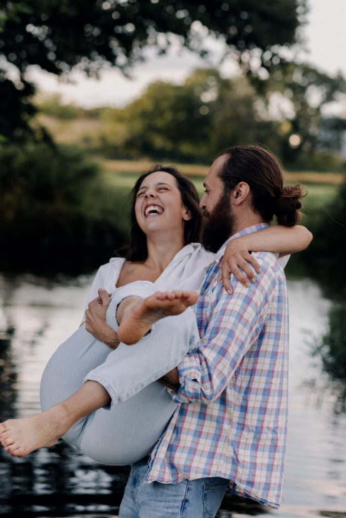 Fun and playful photo of mum lifting his partner. the lady is laughing and enjoying the natural moment. Couple's photographer in Hampshire. hampshire family photographer. Ewa Jones Photography